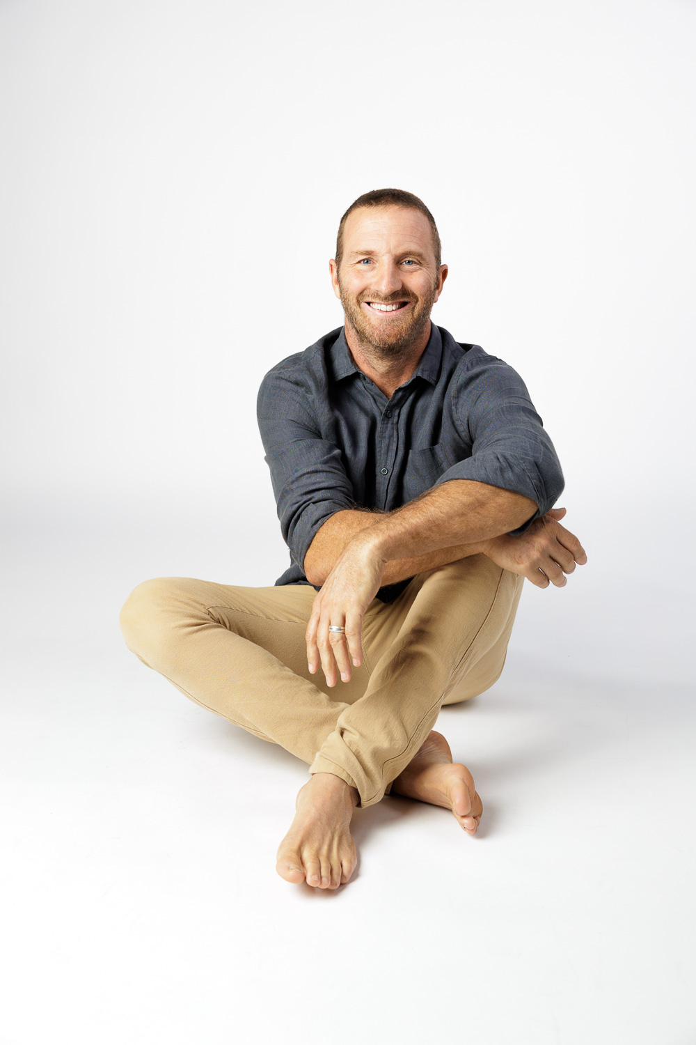 Rich Muir smiling directly at the camera, seated comfortably